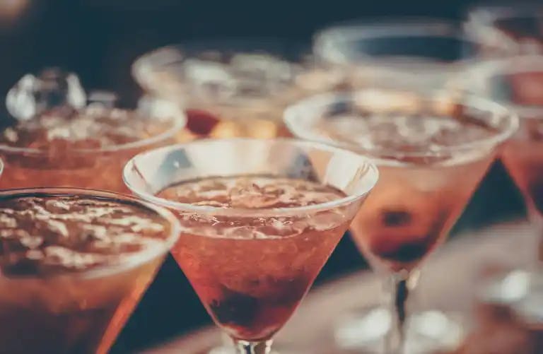 A line of classy cocktails prepped on a bar